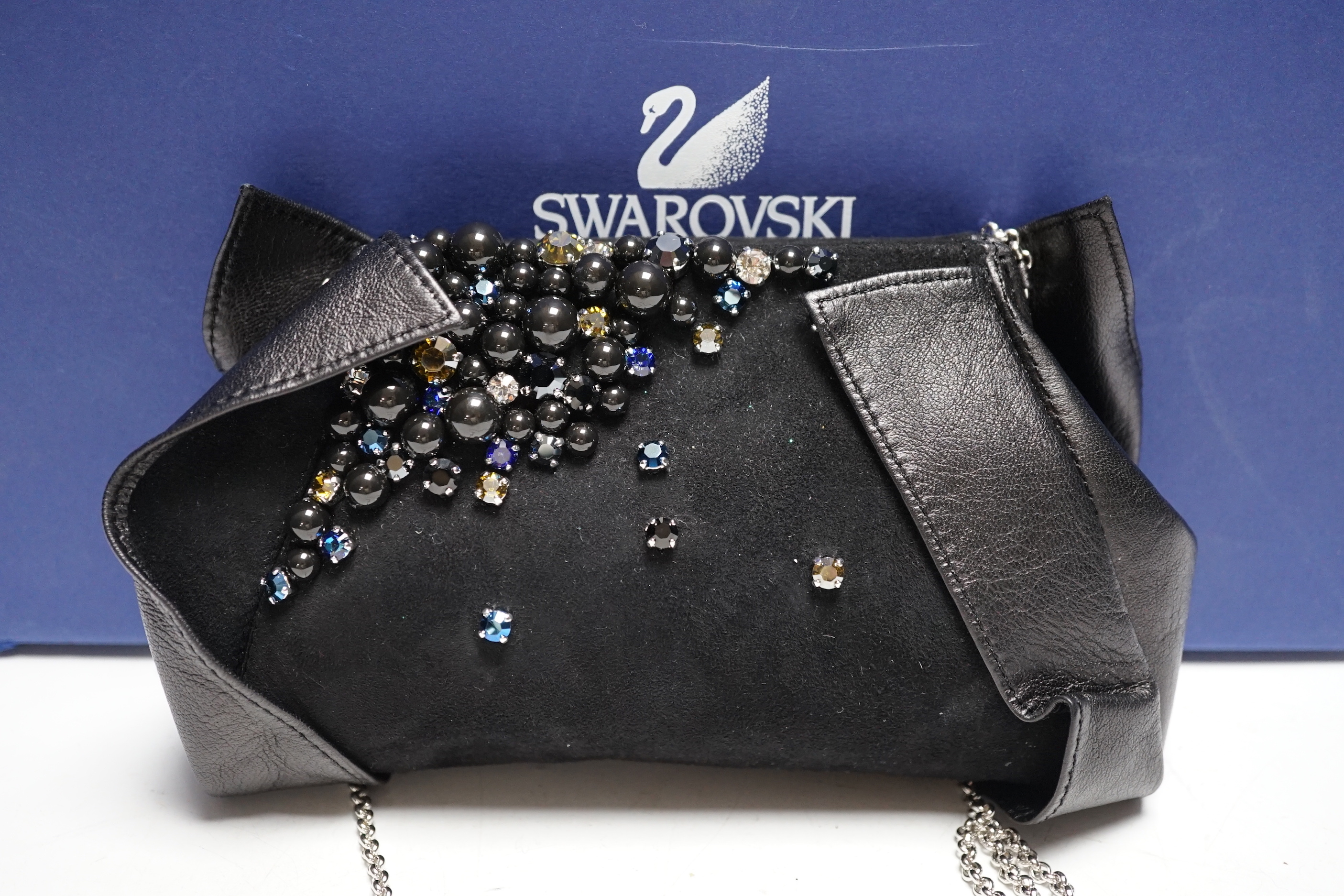 A Swarovski diamanté decorated black suede and leather evening bag, with chain handle, dust bag, box and cover